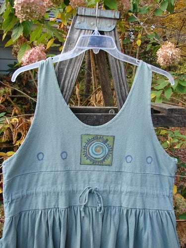 The 1996 Amusement Jumper Round Wind Trinket Size 1 features a unique draw cord back and super elastic front pockets, displayed on a hanger, highlighting its ribbed hem and detailed rounded wind theme.