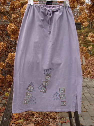 1996 Reprocessed Drawcord Skirt Primitive Mulberry Size 2, featuring a full drawcord waist, slightly widening rectangular shape, and colorful modern faces design on heavy-weight reprocessed cotton with 6-inch side vents.