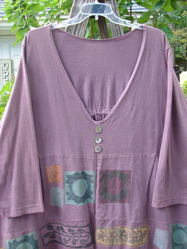 1993 Modernismo Pullover Cardigan Nature Plum Wine Altered Size 2 displayed on a clothes rack, showcasing three decorative buttons, kangaroo pockets, and a thick hemline.
