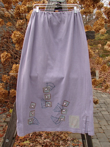 1996 Reprocessed Drawcord Skirt Primitive Mulberry Size 2 hanging on a clothesline, showcasing a full drawcord waist, slightly widening rectangular shape, and side vents in heavy weight cotton.