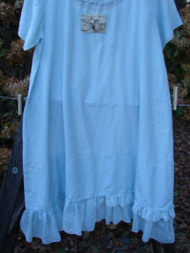 Magnolia Pearl Voile Tie Neck Peasant Tunic, blue dress on clothesline, fluttery ruffle edge, love theme patch