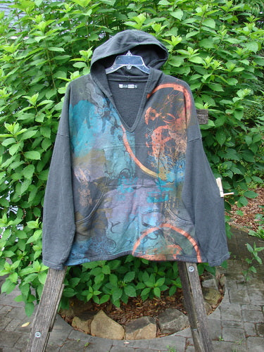 Barclay Cotton Hemp Roo Pocket Hoodie Pullover Metallic Path Black OSFA displayed on a wooden stand, showcasing its kangaroo pocket, hood, and distinct A-line shape, epitomizing vintage Blue Fish Clothing's unique style.