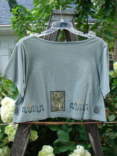 1993 Travel Top Many Moons Ocean Size 2, displayed on a hanger, showcases a deeply scooped neckline, crop shape, painted moons theme, and unique wooden buttons.