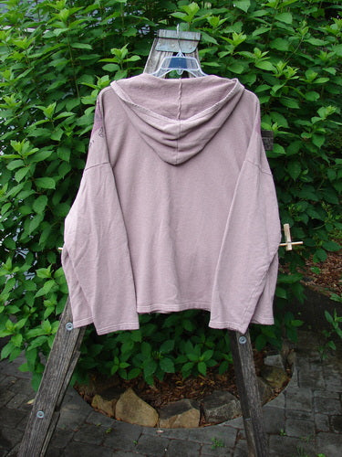 Barclay Cotton Hemp Roo Pocket Hoodie Pullover Crystal Mauve OSFA displayed on a wooden ladder, showcasing its cozy fleece texture, generous A-line shape, and distinctive kangaroo front pocket.