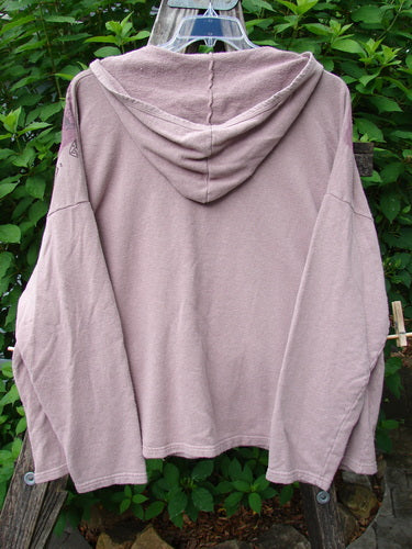 Barclay Cotton Hemp Roo Pocket Hoodie Pullover, featuring a cozy hood, kangaroo pocket, and A-line shape, elegantly displayed on a clothes rack, showcasing Bluefishfinder.com's vintage-inspired style.