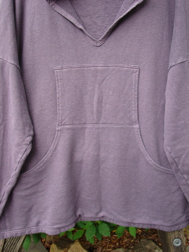 Barclay Cotton Hemp Roo Pocket Hoodie Pullover Rear Birdie Plum OSFA, showcasing cozy cotton terry fleece texture with a distinctive kangaroo pocket and domain shoulders, highlighted in a close-up of the sweatshirt's sleeve detail.