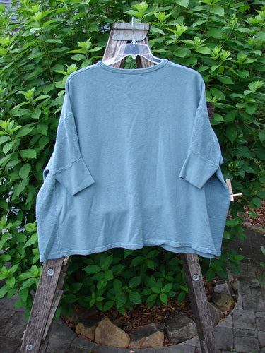 Barclay Hemp Cotton Banded Sleeve Colors Sweatshirt, featuring a wide boxy shape and dolman banded lower sleeves, displayed outdoors on a hanger, showcasing its textured hemp side panels and cozy fall fabric.