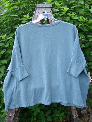 Barclay Hemp Cotton Banded Sleeve Colors Sweatshirt Single Bloom Cypress OSFA displayed on a hanger, showcasing its wide boxy shape, dolman banded sleeves, and contrasting hemp side panels.