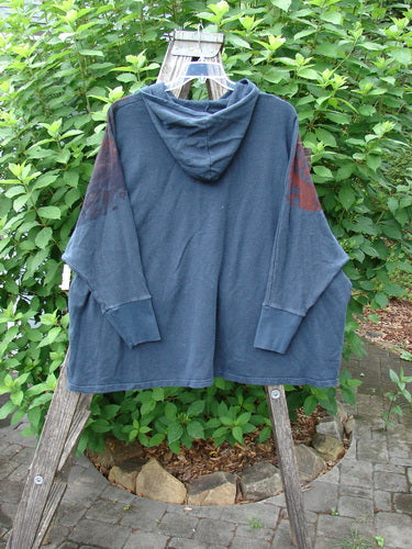 Barclay NWT Cotton Hemp Hooded Folklore Pullover Beach Bird Atlantic OSFA displayed on a wooden rack, showcasing its cordless hood, long sleeves, dual exterior pockets, and wide, flared shape.