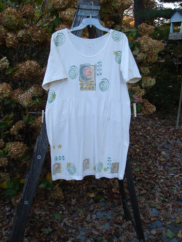 1992 Little Storma Dress Moon White OSFA displayed on a metal swinger, showcasing a deep rounded neckline, celestial moon-themed patches, and original variegated silk ribbon accents.
