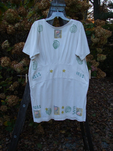 1992 Little Storma Dress Moon White OSFA features a white dress with intricate green celestial designs, deep rounded neckline, and gathered rear, accentuated with variegated silk ribbons and signature Blue Fish Vintage Patch.