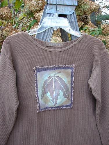 1997 PMU Patched Thermal Long Sleeved Top Leaf Mandorla Size 1: Brown sweater with leaf design, rolled neckline, and tapered waistline. Cozy layering basic.