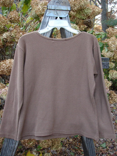 1997 PMU Patched Thermal Long Sleeved Top Leaf Mandorla Size 1: A long sleeved brown shirt with leaf patch and whip stitchery border.