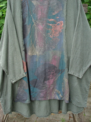 Barclay Cotton Hemp Exterior Stitch Hi Low Tunic Metallic Floral Green Stick OSFA, featuring dolman sleeves, metallic floral design, and curvy stitching, showcased in a cozy outdoor setting, epitomizes BlueFishFinder's unique vintage style.