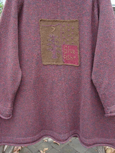 Close-up of the 1998 Patched Alpaca Roll Neck Raglan Sweater in Wineberry Tweed OSFA, showcasing its ribbed collar, oversized leaf patch, and textured marled alpaca wool, embodying Bluefishfinder.com's vintage elegance.