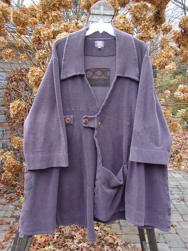 2000 Patched Celtic Moss Highlander Coat Aubergine Size 0, displayed on a hanger, featuring a large collar, empire waistline, horizontal seams, three front buttons, and a lower front pocket.