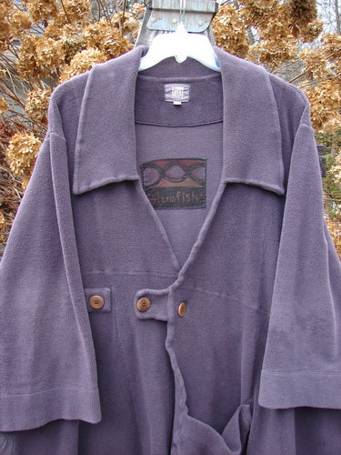 2000 Patched Celtic Moss Highlander Coat Aubergine Size 0 displayed on a hanger, showcasing its dense plush fleece fabric, large collar, horizontal and diagonal seams, and three front buttons with varying closures.
