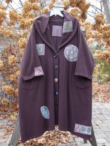 1994 Patched Wool Falling Snow Coat Plum Wine OSFA adorned with floral patches, featuring a huge shawl collar, deep side pockets, vintage buttons, and a flared A-line swing.