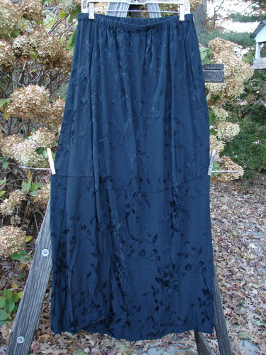 Barclay Brocade Willow Skirt Unpainted Black Size 2: A close-up of a blue skirt with a trailing floral pattern, interesting side accents, and a uniquely paneled lower. Made from embroidered rayon, this skirt is a perfect addition to your wardrobe.