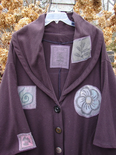 1994 Patched Wool Falling Snow Coat Plum Wine OSFA featuring multi-colored patches, deep side-entry pockets, and a large shawl collar, capturing vintage Blue Fish Clothing's creative and unique style.