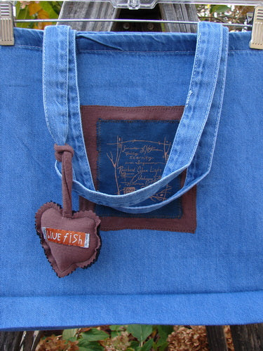 1998 PMU Patched Tote Bag Fall Quad Washed Denim One Size, featuring a colorful puffy heart accent, tote length shoulder straps, and gusset bottom, crafted from lightweight cotton denim for vintage style.