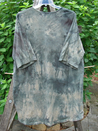 Barclay Tournesol Tunic Wind Script Mottled Green Earth OSFA, displayed on a rack, features a tie-dye pattern, loose three-quarter sleeves, and a varying hemline, embodying Bluefishfinder.com's vintage, expressive style.