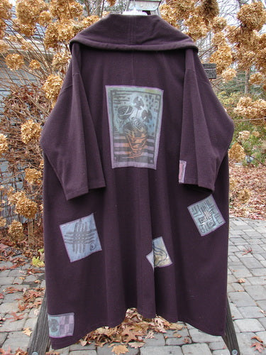 1994 Patched Wool Falling Snow Coat Plum Wine OSFA, featuring a hood, oversized cape-like design, multi-colored patches, deep pockets, and vintage Blue Fish buttons.