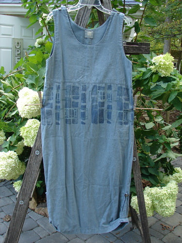 2000 Almost Seven Jumper Stone Path Blue Mineral Altered Size 1 displayed on a wooden ladder, showcasing button shoulders and a rounded neckline, with tabbed sides and a tapering hemline.