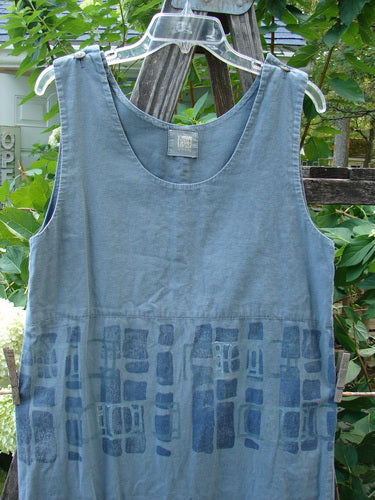 2000 Almost Seven Jumper Stone Path Blue Mineral Altered Size 1 hanging on a clothesline, showcasing its button shoulders, rounded neckline, and tabbed hem, highlighting its lightweight hemp fabric and unique design.