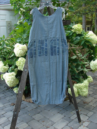 2000 Almost Seven Jumper Stone Path Blue Mineral Altered Size 1 displayed on a wooden stand, featuring button shoulders, a deeper neckline, tabbed sides, and a tapering hemline with a stone path design.