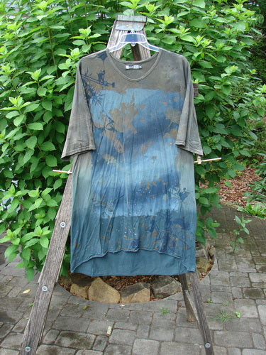 Barclay Tournesol Slim Tunic Sea Botanicals Mottled Brown Ocean OSFA features a loose fit, drop shoulders, and a varying hemline, showcased outdoors on a hanger, highlighting its artistic sea botanicals design.