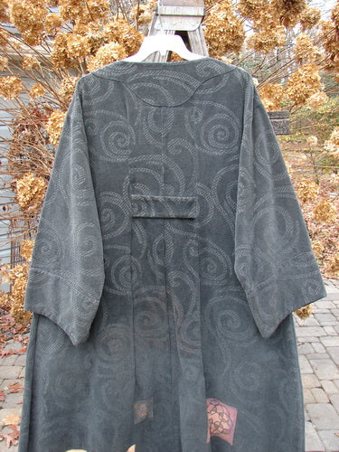 2000 Patched Upholstery Diwmach Coat Swirl Black Size 2 displayed on a hanger, featuring colorful patches, a scalloped neckline with vintage buttons, belled sleeves, and a pleated, tabbed rear.