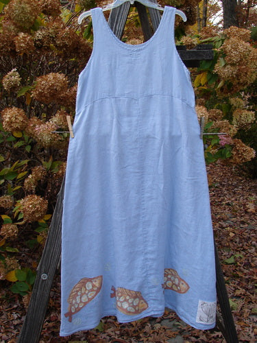 2000 Summer Shift Dress Fish Stream Size 1: Blue dress with fish pattern, curved empire waist, flared lower, and straight upper bodice, hanging outdoors on a clothesline.