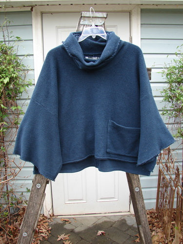 Barclay Patched Celtic Moss Crop Cowl Neck Pullover Navy OSFA displayed on a wooden stand, showcasing its floppy cowl neck, oversized crop fit, and wide dolman sleeves from Bluefishfinder.com's vintage-inspired collection.