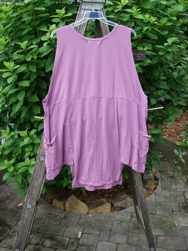 Barclay Flowerpot Top Promotional Fish Peony OSFA displayed on a clothes rack, showcasing its unique drop front pockets, rounded ribbed neckline, and flared A-line shape with sectional panels.