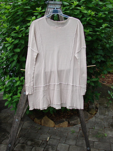 Barclay Cotton Mesh Exterior Stitch Sectional Overtop Unpainted Pink Cloud Size 2 displayed on a clothesline, showcasing its long sleeves, rounded neckline, exterior stitching, and unique hemline, reflecting vintage Blue Fish Clothing style.