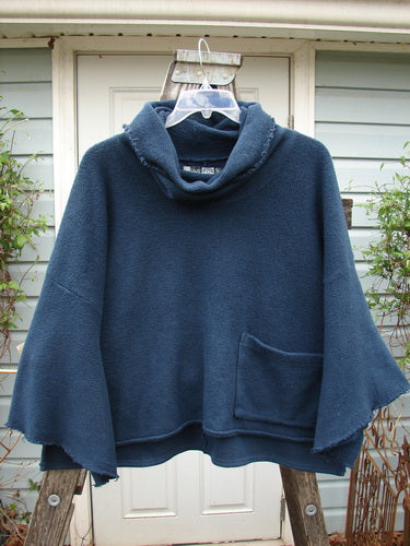 Barclay Patched Celtic Moss Crop Cowl Neck Pullover Navy OSFA on a swing, showcasing its plush texture, oversized fit, floppy cowl neck, and unique dolman sleeves, embodying BlueFishFinder's vintage aesthetic.