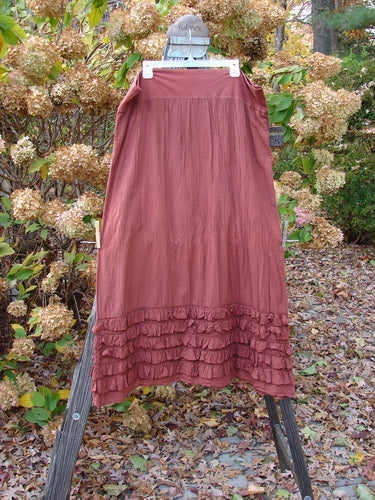 Barclay NWT Voile Foldover Five Ruffle Skirt Unpainted Oxide Clay Size 2 displayed on a rack, showcasing its full cotton thick fold over waist panel and ruffled five-row paneled hemline.