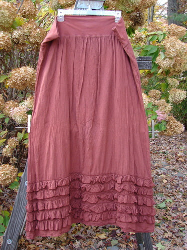 Barclay NWT Voile Foldover Five Ruffle Skirt Unpainted Oxide Clay Size 2 displayed outdoors, featuring a full cotton waist panel and multi-layered ruffled hem, capturing BlueFishFinder's vintage, expressive style.