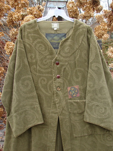 2000 Patched Upholstery Diwmach Coat Swirl Pine Size 2 featuring a damask swirl pattern, colorful patches, scalloped neckline with vintage buttons, belled sleeves, large pocket, and pleated, tabbed rear.