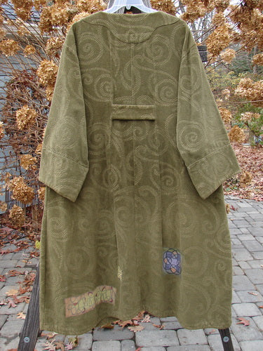2000 Patched Upholstery Diwmach Coat Swirl Pine Size 2 on a clothes rack, featuring a damask swirl pattern, large pocket, scalloped neckline, vintage buttons, belled sleeves, and pleated back.