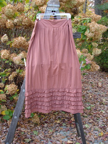 Barclay NWT Voile Foldover Five Ruffle Skirt Unpainted Kiss Cliff Size 2 hanging on a clothesline, showcasing its full cotton waist panel, ruffled hemline, and sweeping A-line shape.