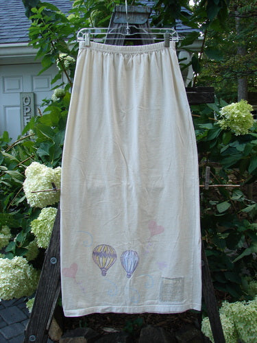 1999 Straight Skirt Air Balloon Natural Size 0: A white organic cotton skirt with hot air balloons painted around the hem and a full elastic waistband, from the 1999 Summer Collection.