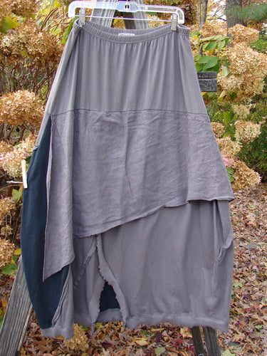 Barclay Mixed Media Swatch Skirt Unpainted Black Plum Size 2 displayed on a clothes rack, showcasing alternating layered upper with sectional panels and a full elastic waistline.