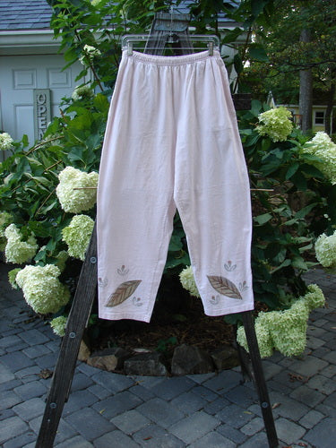 1999 Simple Vent Pant Fallen Leaf Orchid Size 1 displayed on a wooden ladder, showcasing full elastic waistline, lower ankle vents, and inseam side pockets with an organic cotton fallen leaf design.