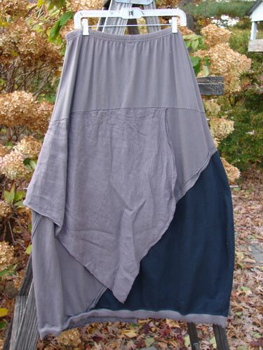 Barclay Mixed Media Swatch Skirt Unpainted Black Plum Size 2 displayed on a clothes rack, showcasing its textured, layered design and elastic waistband.