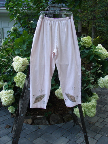 1999 Simple Vent Pant Fallen Leaf Orchid Size 1 hanging outdoors, showcasing full elastic waistline, lower ankle vents, and two side pockets with a leaf-themed design painted on mid-weight organic cotton.