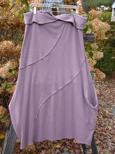 Barclay Cotton Lycra Fold Over Lantern Skirt Stripe Plum Size 2 displayed outdoors, highlighting its fold-over waistline, bell shape, and distinctive exterior stitching.