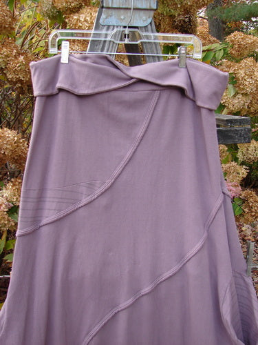 Barclay Cotton Lycra Fold Over Lantern Skirt Stripe Plum Size 2 hanging on a clothesline, showcasing its unique fold-over waistline and curvy exterior stitchery, highlighting its vintage and creative design.