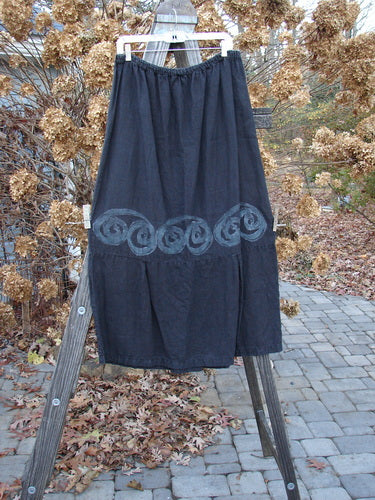 2000 Pages Market Duo Celtic Black Size 2: A skirt with a swirl design on a wooden ladder.